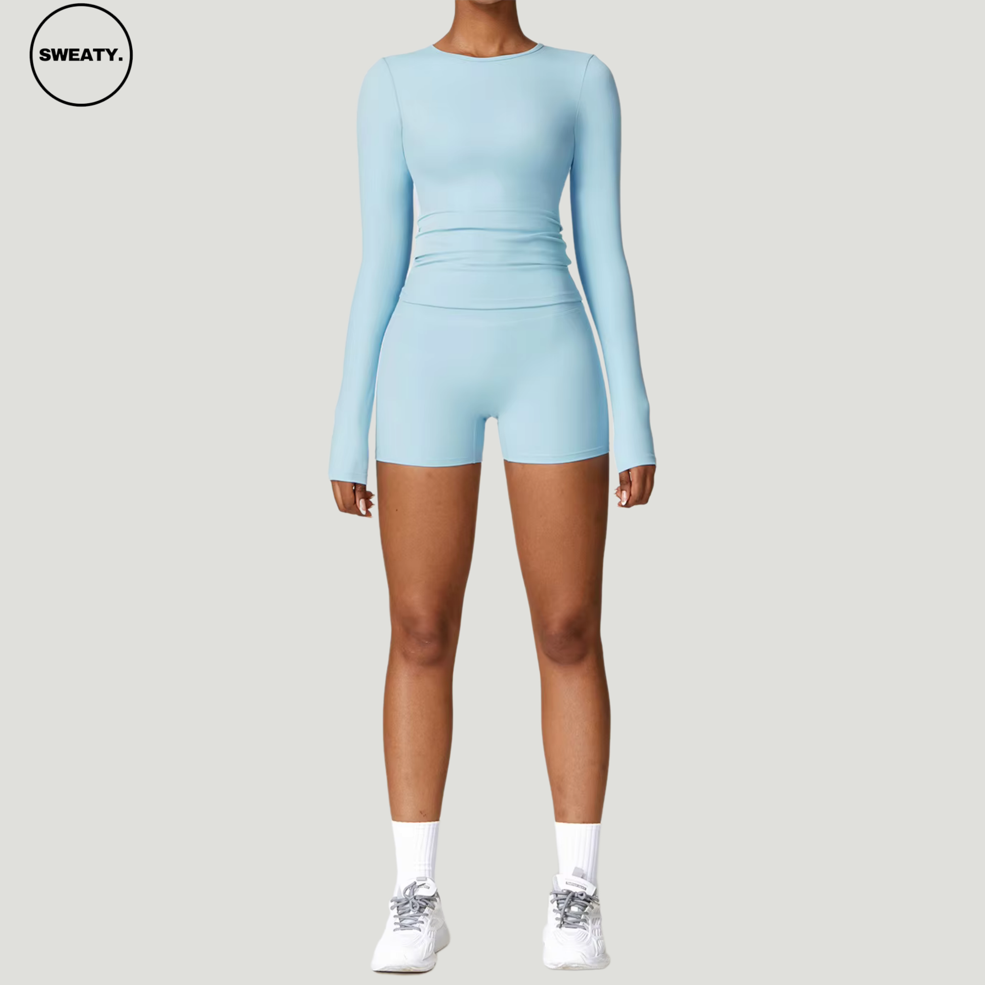 Sky Blue seamless yoga set by SWEATY – front view of long-sleeve crop top and high-waisted shorts. Perfect for yoga, running, and gym workouts, made from moisture-wicking and breathable materials.