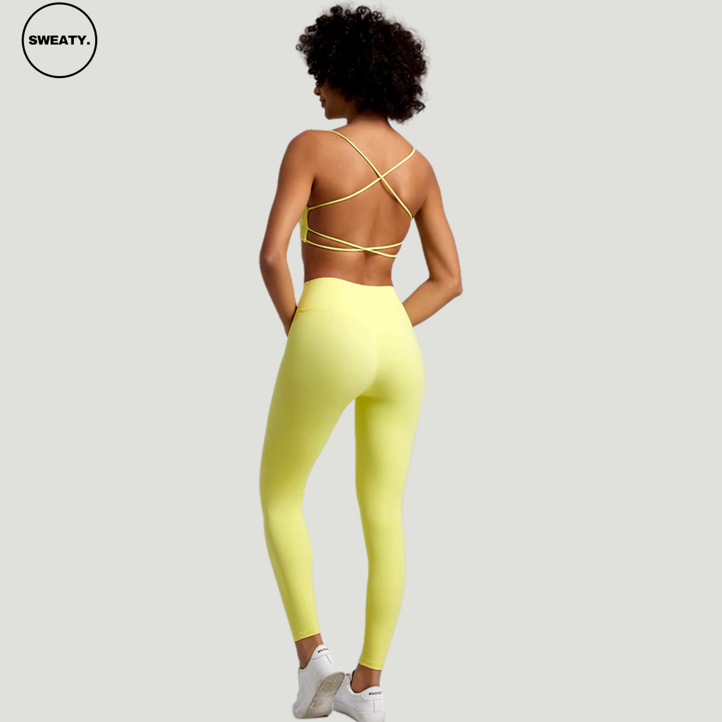 Sunflower Yellow Buttery Soft Gym Set by SWEATY - Eye-catching women's workout set featuring a unique cross-back bra design and seamless leggings in a bright yellow hue. Ideal for gym or yoga sessions where style and comfort are prioritized.