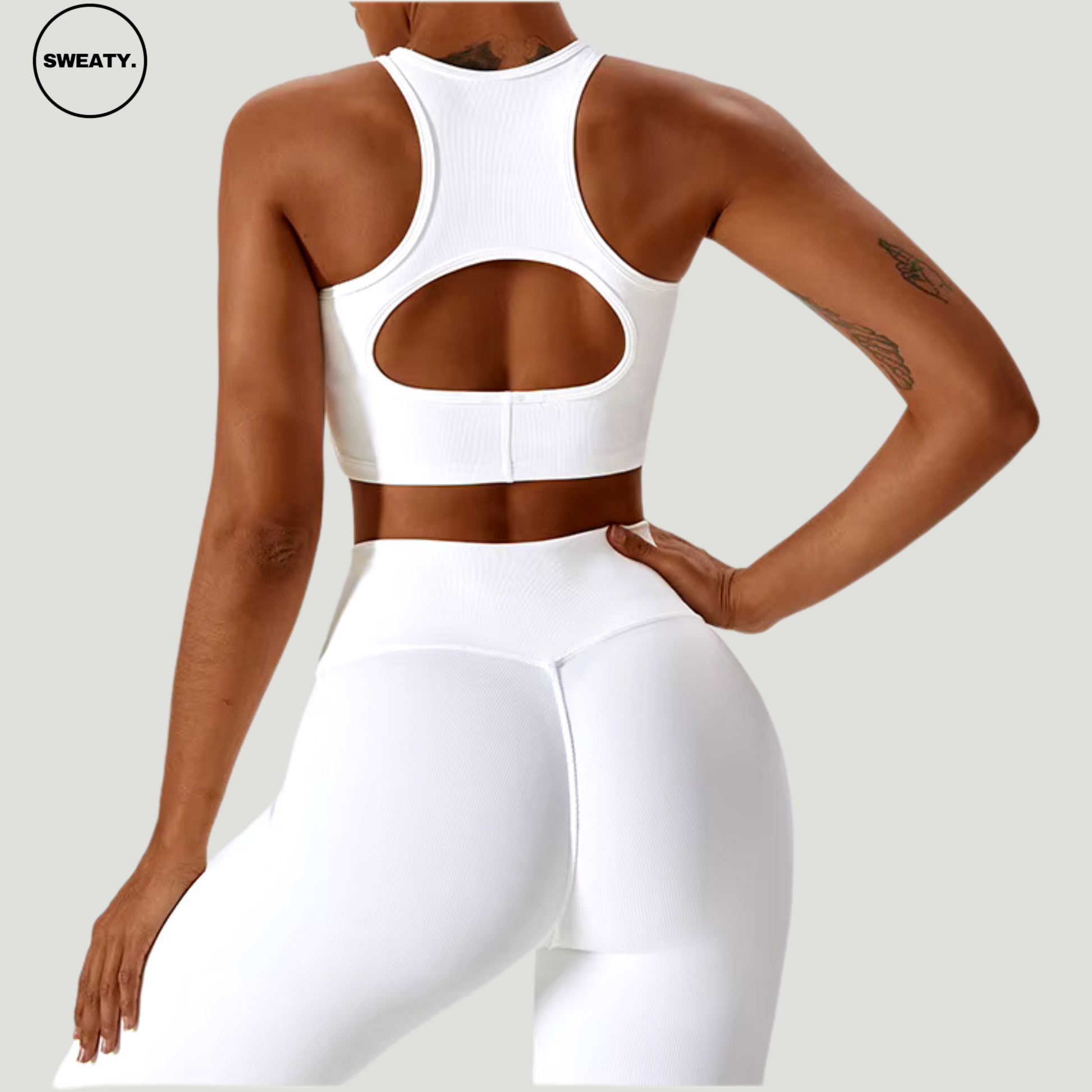 White seamless sportswear set by SWEATY – back view of racerback cutout sports bra and high-waisted leggings. Perfect for yoga and fitness, made with moisture-wicking and breathable fabric for comfort.