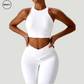 White seamless sportswear set by SWEATY – front view of high-neck sports bra paired with high-waisted leggings. Designed for gym workouts, yoga, and running with moisture-wicking, breathable fabric.