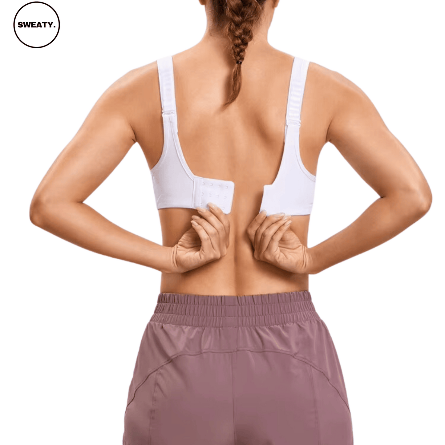 Back view of White Supportive Sports Bra by SWEATY, featuring a hook-and-eye closure being fastened, offering adjustable support and comfort for various activities.