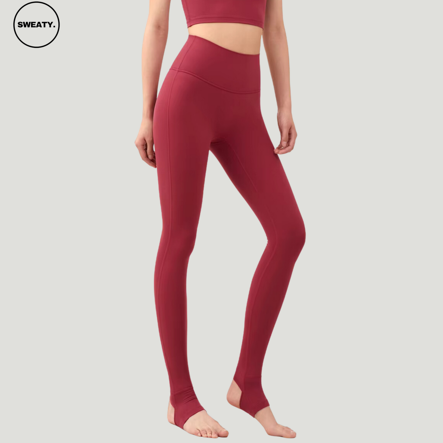 Side view of model wearing Wine Red Breathable Stirrup Yoga Leggings by SWEATY. The stirrup leggings provide full coverage and support, perfect for yoga, dance, and flexibility training.