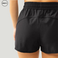 Close-up back view of a black 2-in-1 skort from SWEATY, highlighting the elastic waistband and fabric details designed for comfort and flexibility during workouts.