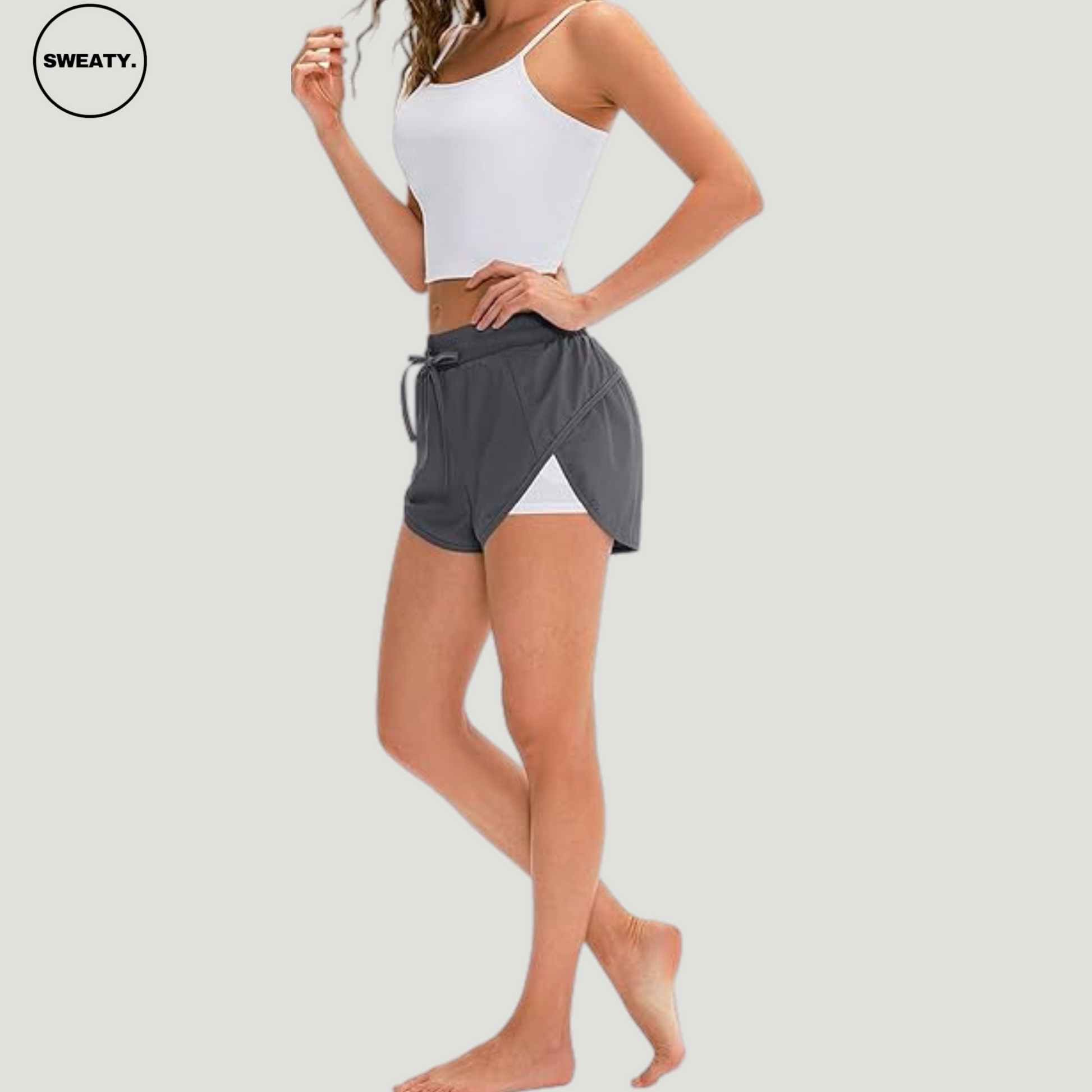 Side view of a gray 2-in-1 skort from SWEATY, featuring a wrap-around design with an elastic waistband and inner shorts for comfortable movement during exercise.