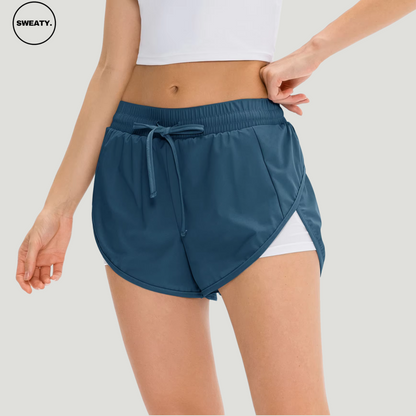 Front view of an ocean blue 2-in-1 skort from SWEATY, featuring a drawstring elastic waistband and layered design for enhanced mobility and breathability during fitness activities.